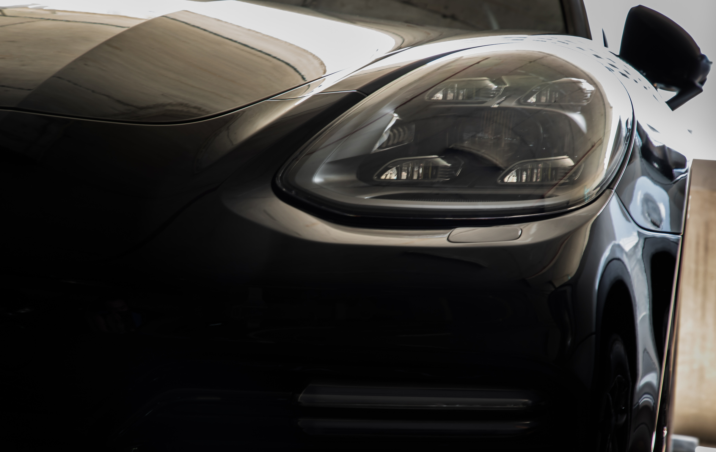 Close-up of Headlights of Black Porsche Car.